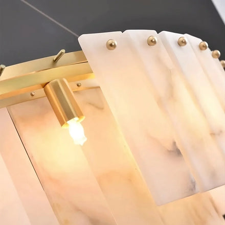 Close view of the chandelier’s stone panels and metal detailing