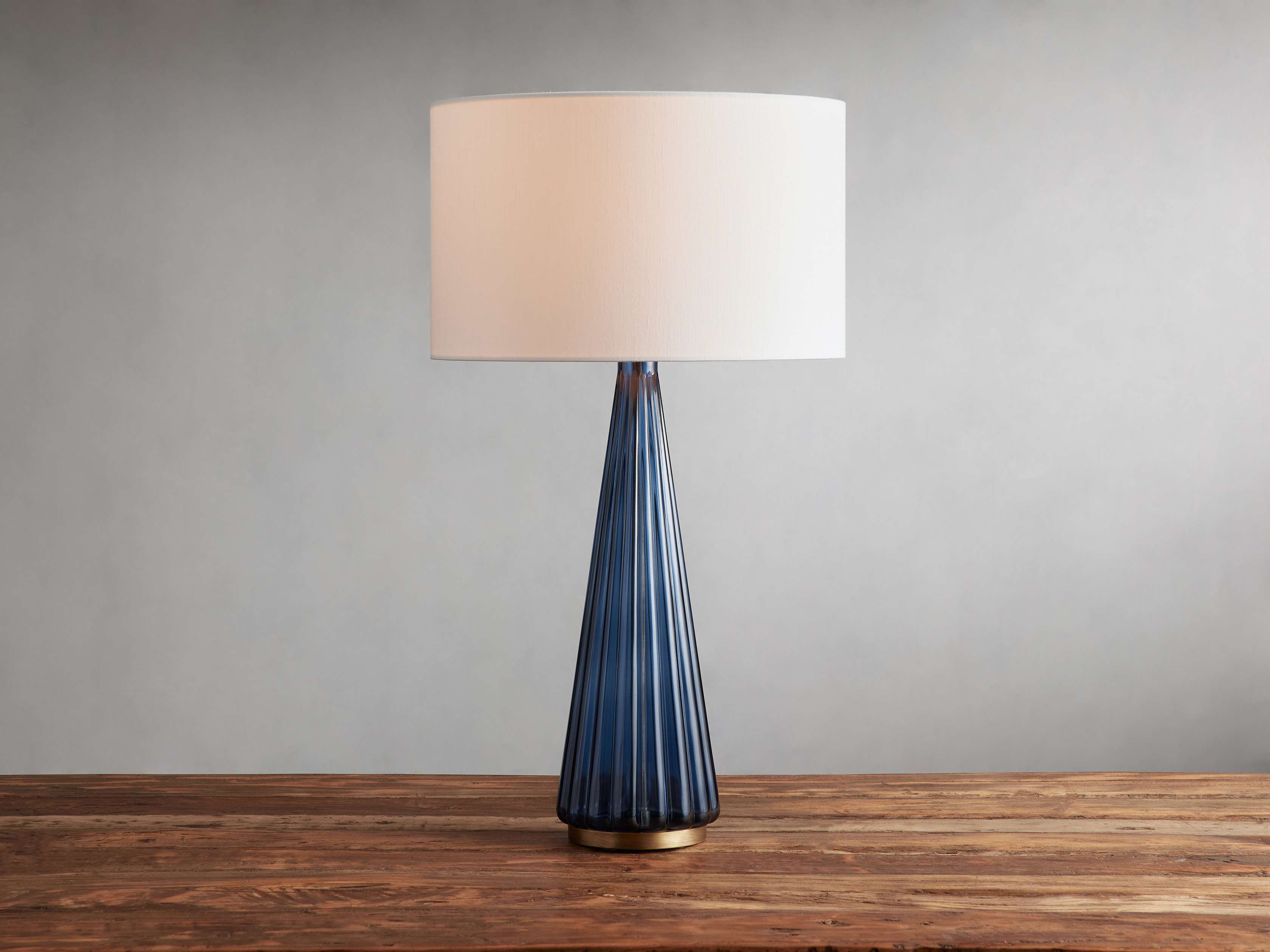 Side view of glass table lamp for scale and shape reference