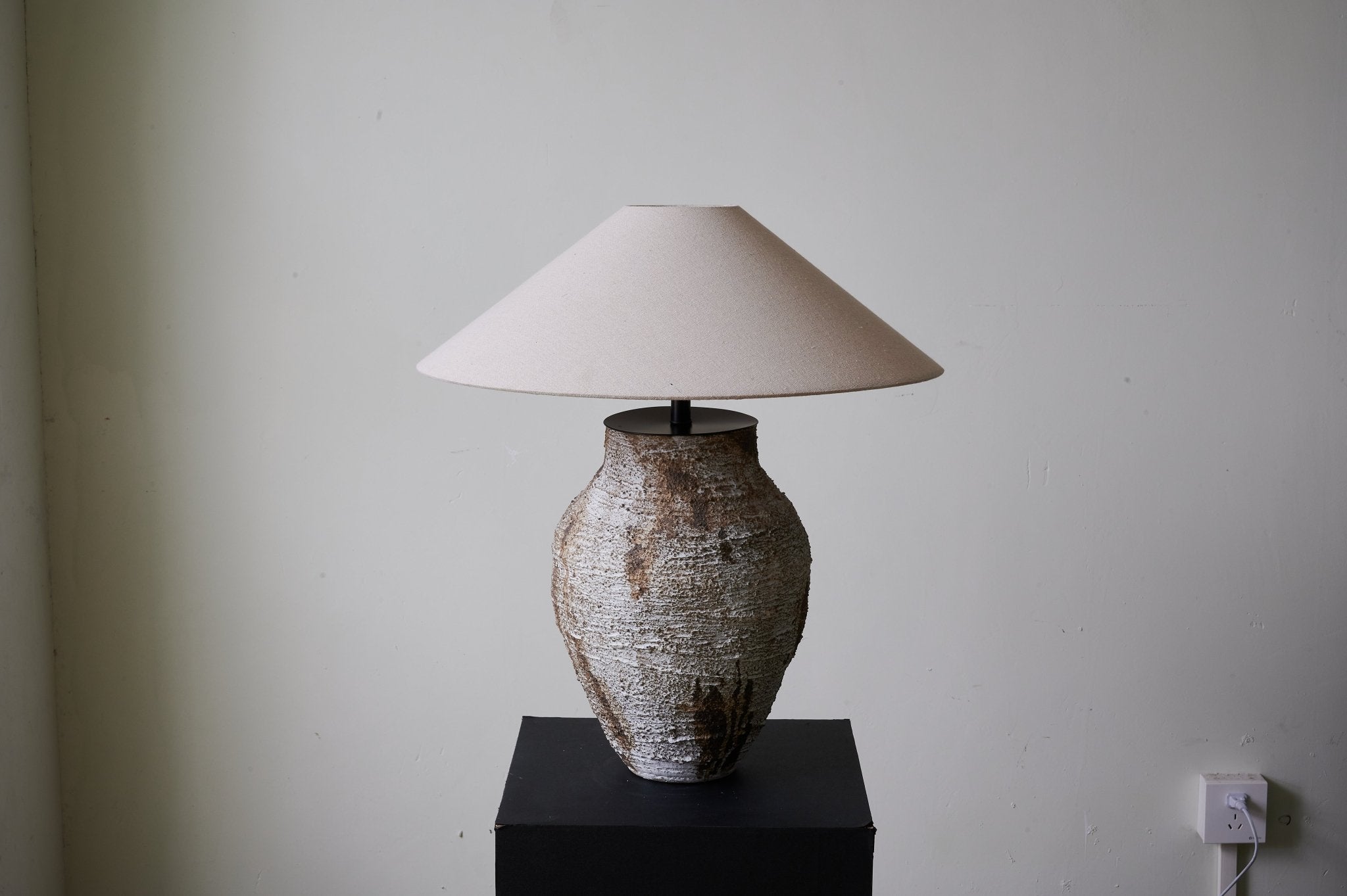 Side view of ceramic table lamp for scale and shape reference