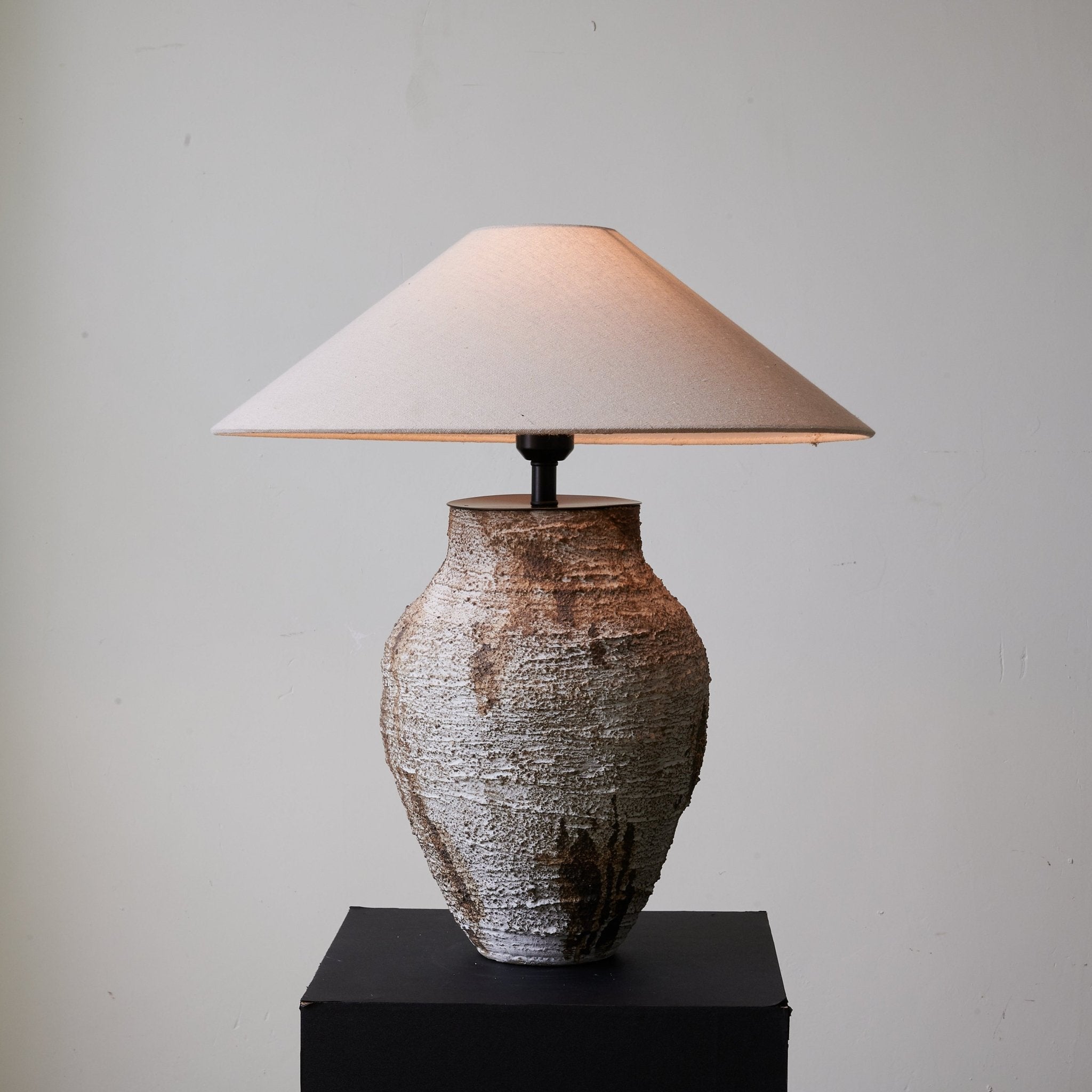 Side view of ceramic table lamp for scale and shape reference