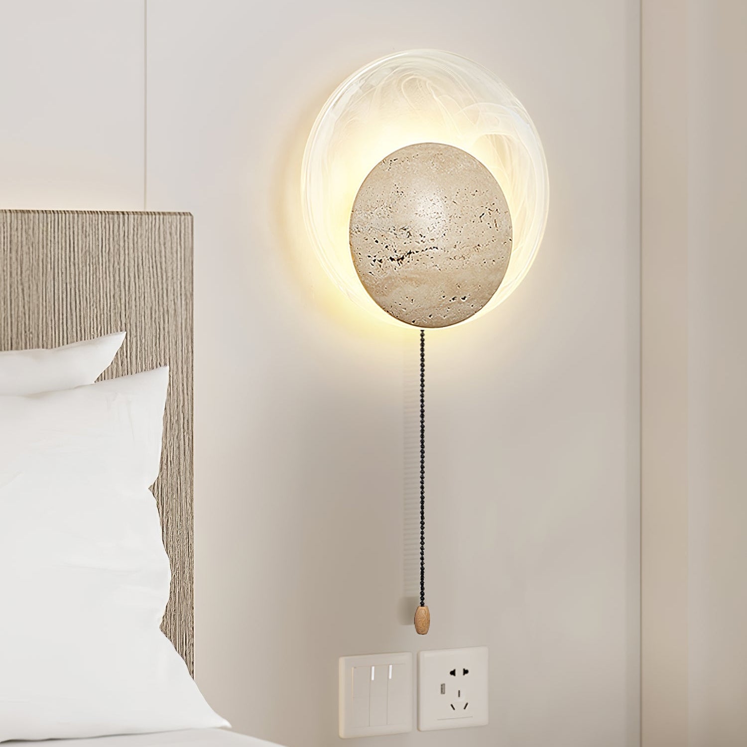Close-up angle of Genesis Travertine Wall Lamp showing form and material detail