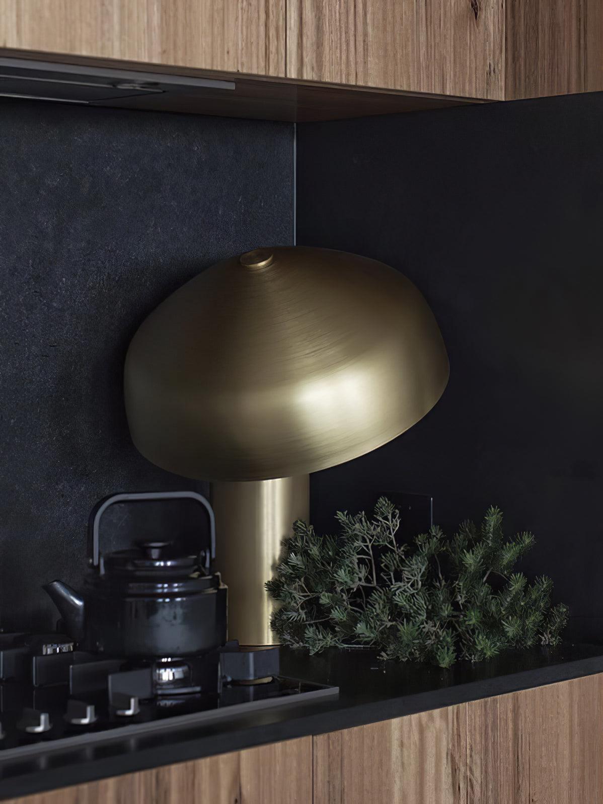 Side view of metal table lamp for scale and shape reference