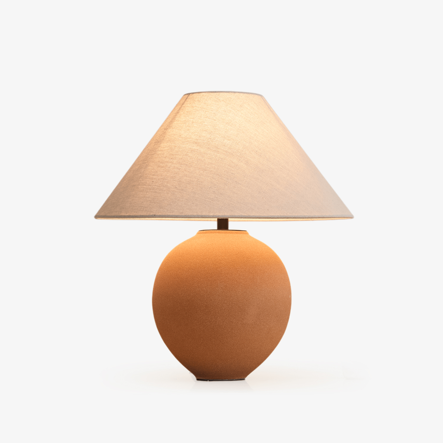 Terracotta Hued ceramic table lamp with warm shade
