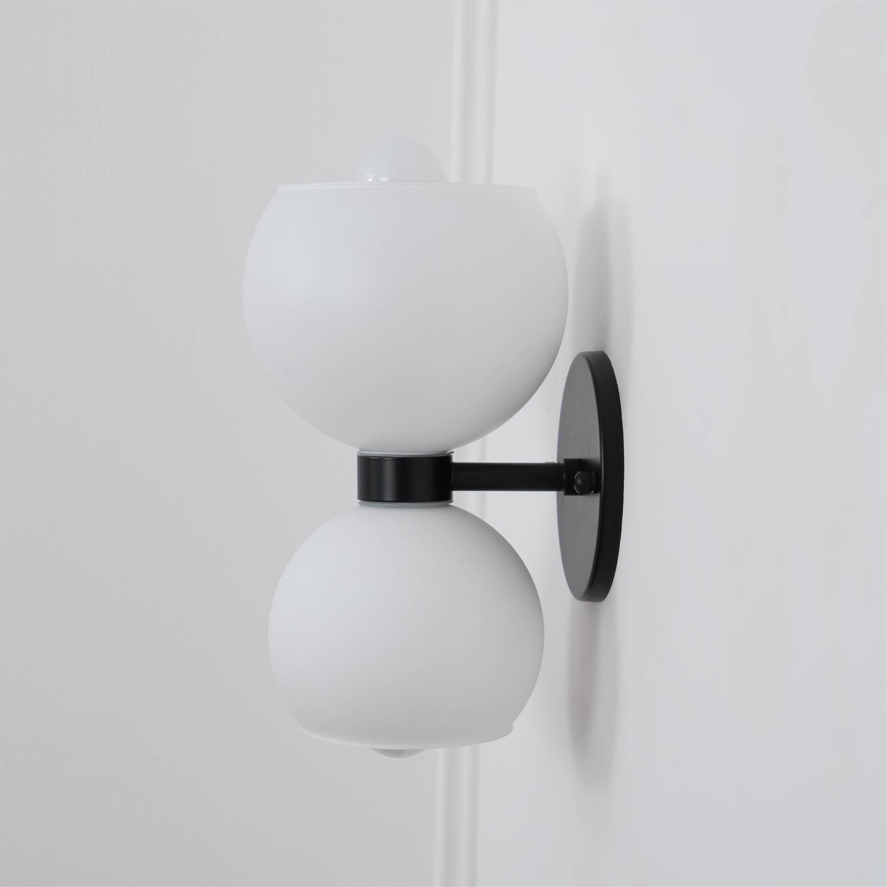 Side view of glass lighting fixture for scale and shape reference