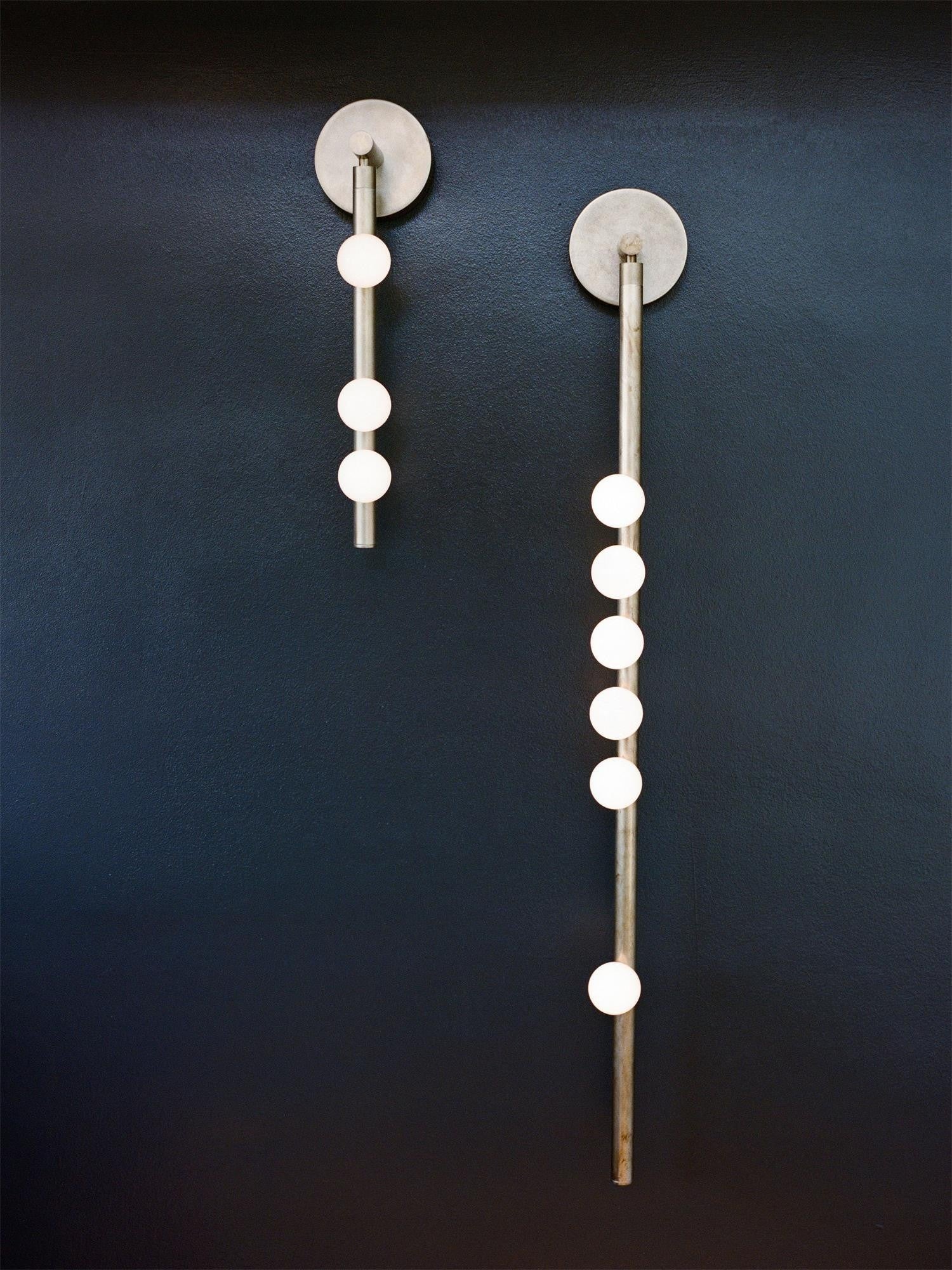 Side view of glass vanity light for scale and shape reference