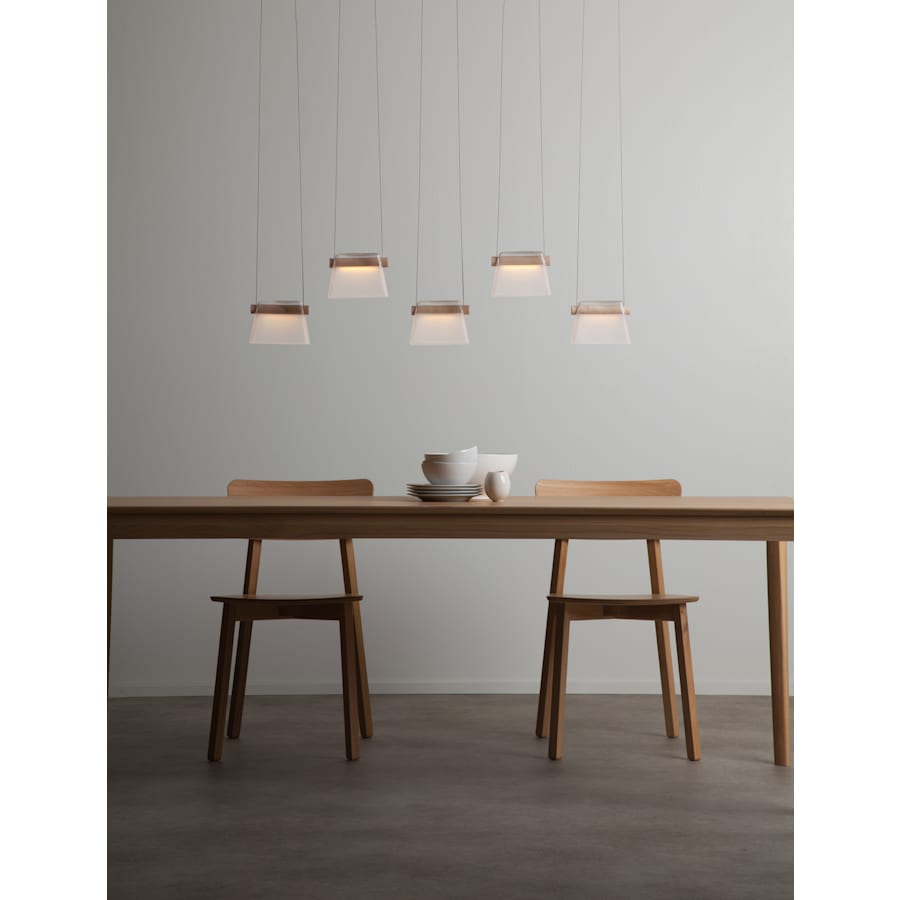 Close-up angle of Cowbell 41" Wide Linear Pendant showing form and material detail